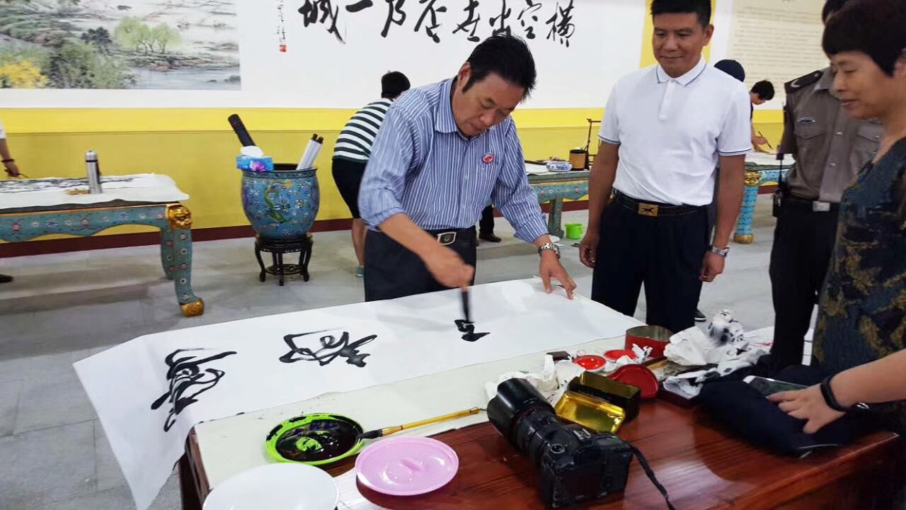 馮雪林在浙江橫店影視城現(xiàn)場創(chuàng)作寧靜致遠(yuǎn)行書書法作品